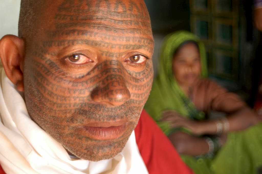 An Asian man with primitive facial tattoos