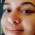 A happy customer with a septum piercing