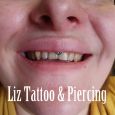 A smiley piercing with a small gem stone