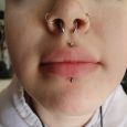A centered labret piercing to match the other facial piercings