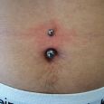 A navel piercing on a guy