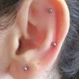 Three piercings in a triangular placement