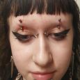 Double eyebrow piercings and other facial piercings.