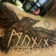 Huggin flying with norse runes inside
