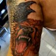 A tattoo of a bear and a raven