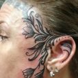 A bold face and ear tattoo
