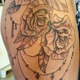 Black and grey roses with pearls on the thigh