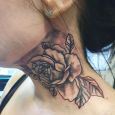 A rose tattoo on the neck