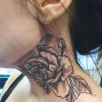 A rose tattoo on the neck