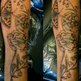 A butterfly and flowers on the forearm
