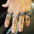 Rock tattooed on the fingers with rings