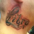 Libra tattooed on the neck with a quill