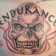 A skull with the word endurance on the chest