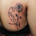A simple line tattoo of flowers
