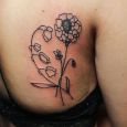 A simple lineart tattoo with flowers